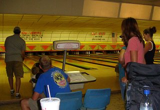 Tim bowling with Jackson, Dallas, Lauren, Tiffany and Heather looking on