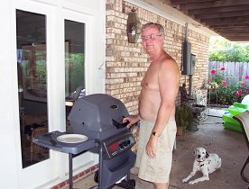 Ken with his new grill, Easton looking on